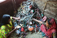 Children sort garbage all day in the slums of Dhaka to make money for their poor families (photo: Michael Lund)