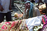 Indian man grieves before his mother's body is burned at Manikarnika Ghat in Varanasi (photo: Michael Lund)